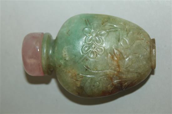 A Chinese pale green and russet jadeite snuff bottle, 1880-1930, 5.9cm